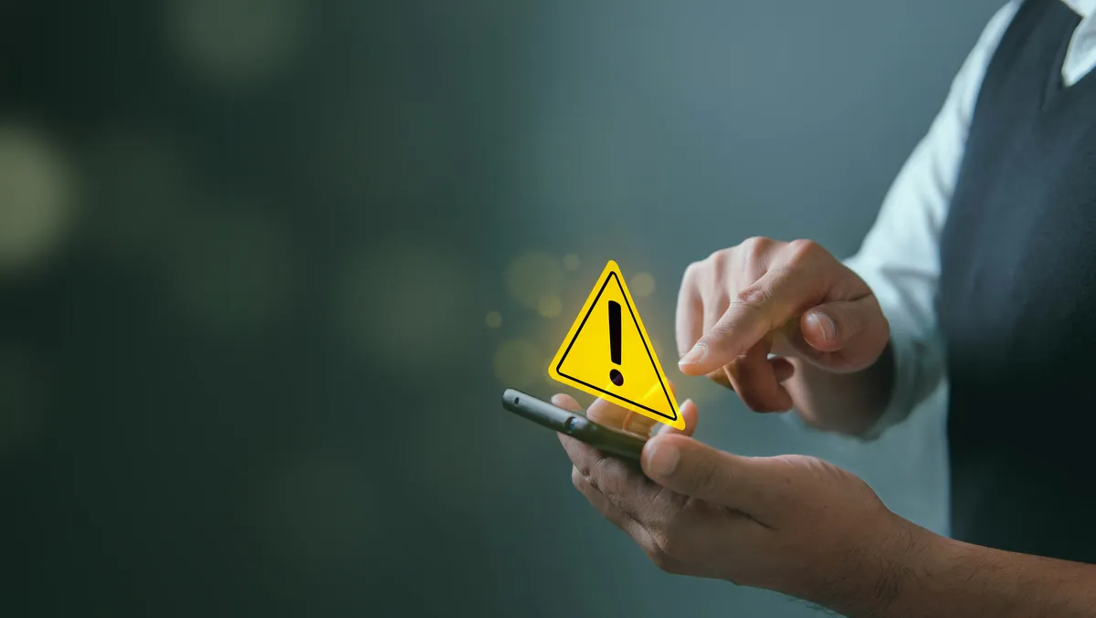 System hacked warning alert, Man using smartphone with cyber attack network, virus, spyware, scam or Malicious software. Cyber security and cybercrime. Compromised information internet.