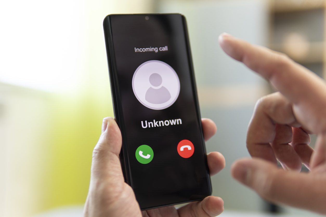 Man holds a phone in his hand. Incoming call from an unknown number.
